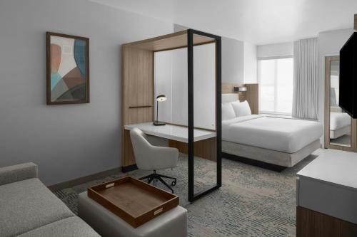 a hotel room with a bed and a desk at SpringHill Suites by Marriott Idaho Falls in Idaho Falls
