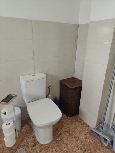 a bathroom with a white toilet and a shower at Maresía La Santa in La Santa
