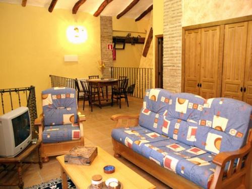 a living room with a couch and a tv at Casa Mairal in Salillas