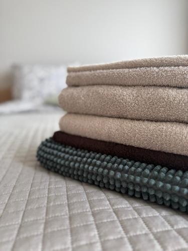 a stack of towels sitting on the floor at Poilsis Kunigiškiuose in Palanga