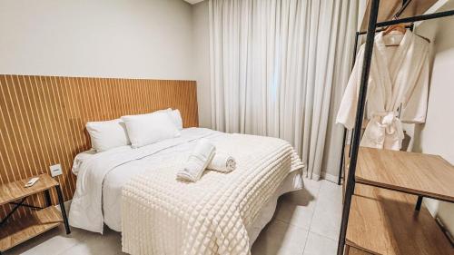 a bedroom with a bed with two towels on it at Apt Afeto Pomerode in Pomerode