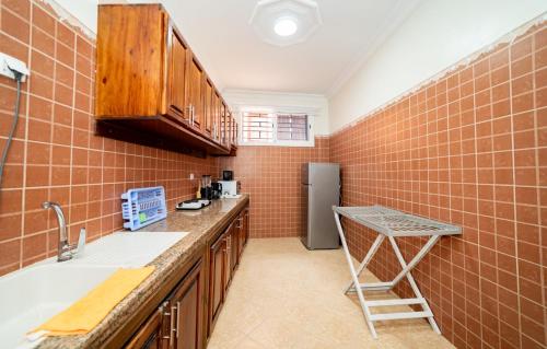 a kitchen with a sink and a refrigerator at Appartement Dar Tamraght in Tamraght Ouzdar
