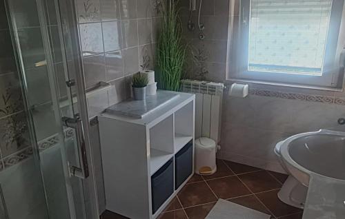 a bathroom with a sink and a toilet and a shower at Villa Lara - Rab by Villas Guide in Rab