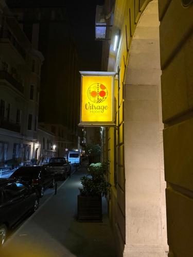 a yellow sign on the side of a building at Vitrage Hotel Baku in Baku