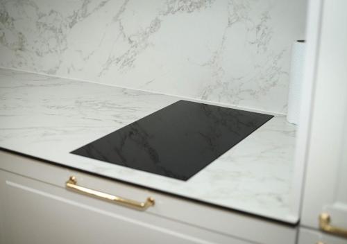 a kitchen drawer with a black and white counter top at Modern Apartment Peje in Peje
