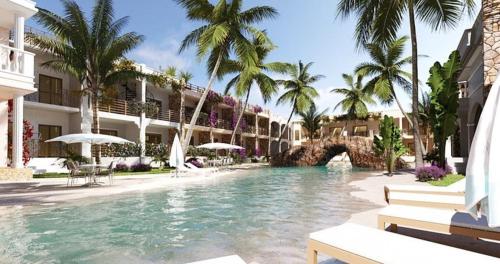 a swimming pool with palm trees and a building at Luxury resort in Jericoacoara