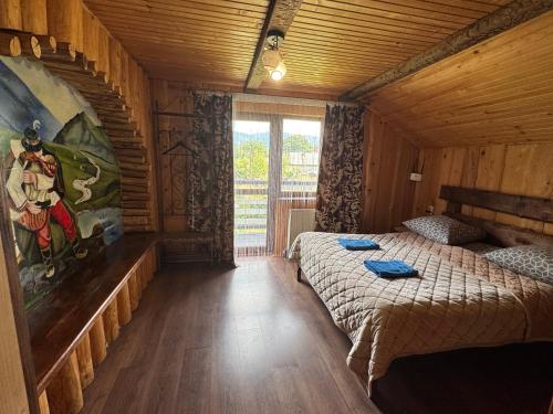 a bedroom with a bed in a wooden house at Villa Zgarda1 in Mykulychyn