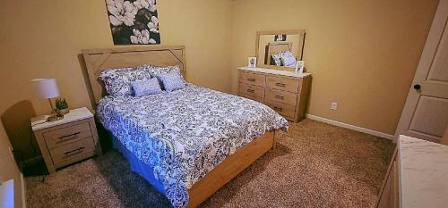 a bedroom with a bed and a dresser and a mirror at Serenity Suite in Grovetown