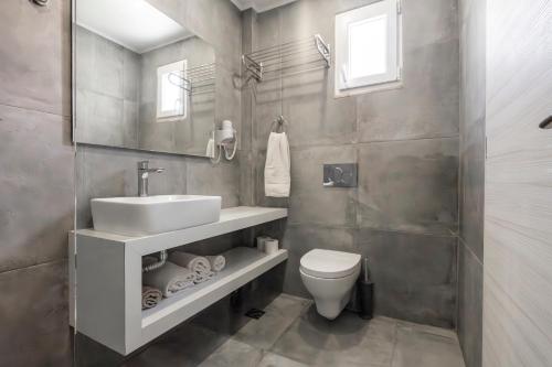 un baño con lavabo e inodoro en Avra Beach, en Ferma