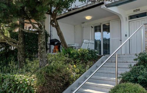 a white house with stairs and a porch at Villa Yadranka with Sea view in Strunjan