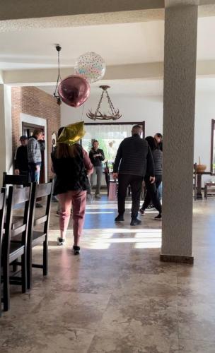 a group of people walking around a room at Valea Salbatica in Şinca Nouă
