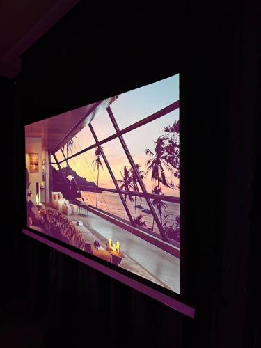 a television screen with a picture of a beach at Love Room 85 in Kortrijk