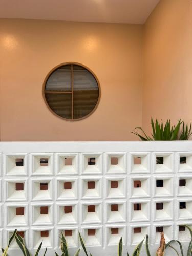 a room with a white wall with a window at Muttafa House in Nai Yang Beach
