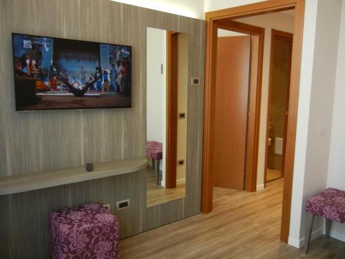 a room with a flat screen tv on the wall at Delle Nazioni Milan Hotel in Milan