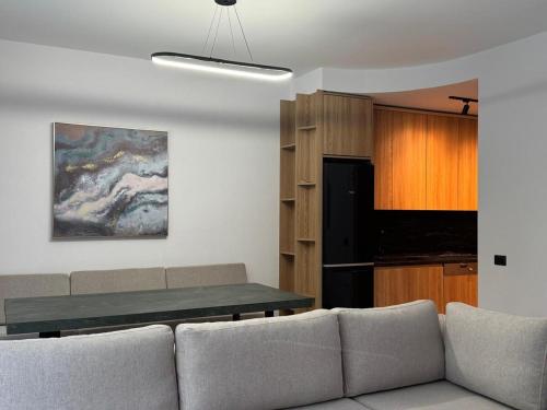 a living room with a couch and a table at Escape by Form Villa Olea 3 with pool in Dhërmi