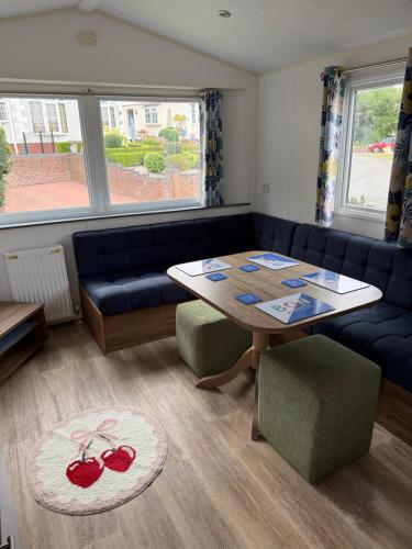 a living room with a table and a couch at Severn valley caravan park in Quatford