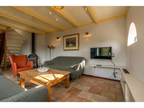a living room with a couch and a table at Farmhouse Lodge in Texel near the Dyke in Oost