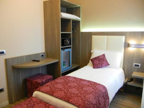 a hotel room with a bed and a desk at Delle Nazioni Milan Hotel in Milan
