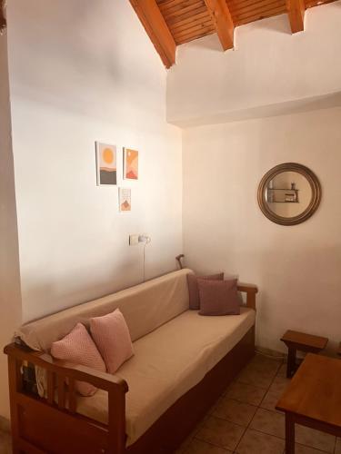 a couch in a living room with a mirror at Grandpa's Chill House in Oítilon