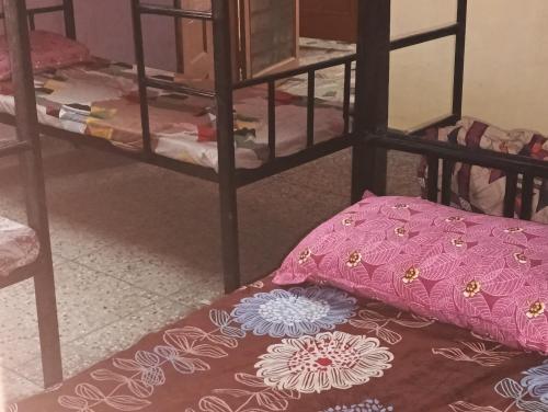 a room with two bunk beds with a pillow on the floor at Wander Vibes Female DROM in Lucknow