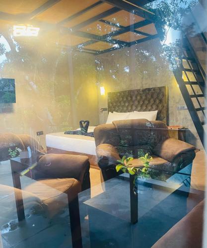 a bedroom with a bed and a couch and a table at Fair View Cottage in Ella