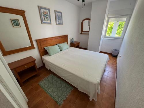 a bedroom with a white bed and a mirror at Lamedos in San Luis de Sabinillas
