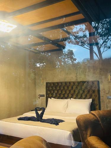 a bedroom with a bed with a large window at Fair View Cottage in Ella