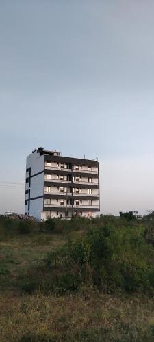 a large building on top of a field at N&G Blessed Pioneer Holiday Homes in Mombasa