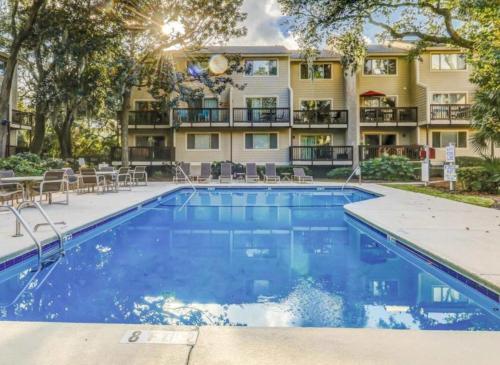 a swimming pool in front of a building with a hotel at Forest Beach Villa - 2 BDR for 6 in Hilton Head Island