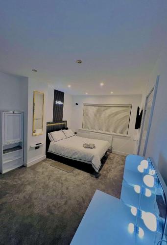 a bedroom with a bed and a television in it at Luxeliving The Larch Residence in High Hazels