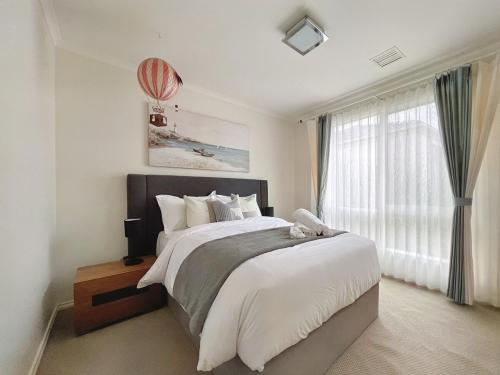a bedroom with a large bed and a large window at No 58 Bright & Spacious 4-Bedroom Home in Doncaster
