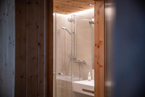 a bathroom with a shower and a sink at Hotel Gasthaus Schäfle in Bürserberg