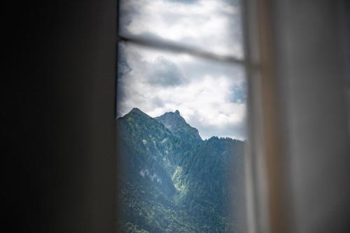 a view of a mountain through a window at Hotel Gasthaus Schäfle in Bürserberg