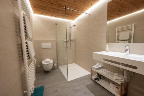 a bathroom with a shower and a sink and a toilet at Hotel Gasthaus Schäfle in Bürserberg