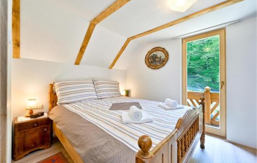 a bedroom with a bed with two towels on it at Kuća za odmor Dedino ognjište in Varaždin Breg