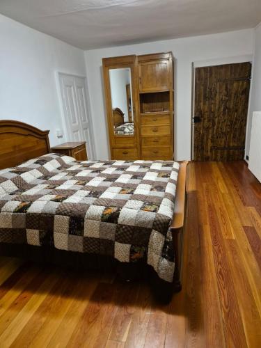 a bedroom with a bed with a checkered blanket at L'Appartamento d'Elda in Santa Maria Maggiore