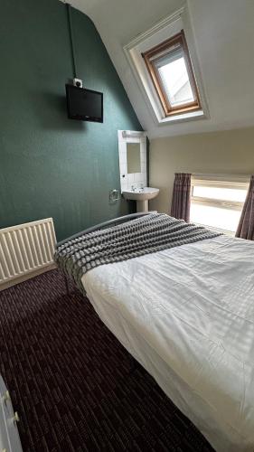 a bedroom with a large bed and a window at Bronte House - Blackpool in Blackpool