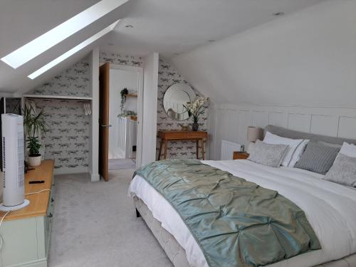 a bedroom with a bed and a table and a mirror at Nanny lane loft in Church Fenton