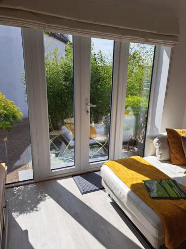 a bedroom with a bed and a large window at Nanny lane loft in Church Fenton