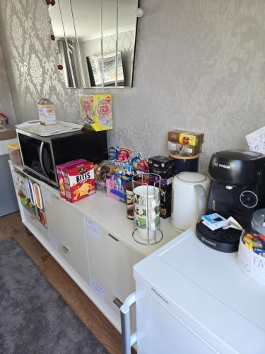a kitchen with a counter with food and a microwave at Luxury on a Budget Chelmsford - B&B ROOM in a quiet family home in Chelmsford