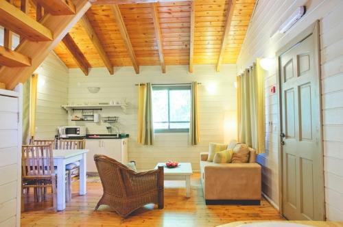 a kitchen and living room with a table and a couch at Ein Zivan Village Resort in Ein Zivan
