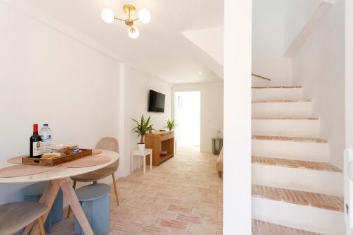 a room with a table and a staircase at Alma Marina Lagos in Lagos