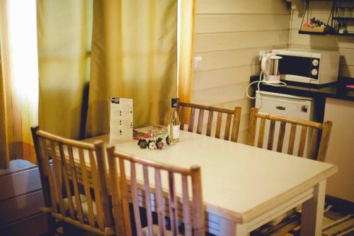 a table with two chairs and a bottle of wine on it at Ein Zivan Village Resort in Ein Zivan