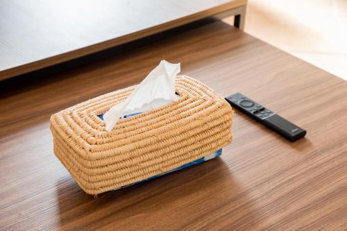 a wicker basket sitting on a table next to a remote control at Appartement Dar Tamraght in Tamraght Ouzdar
