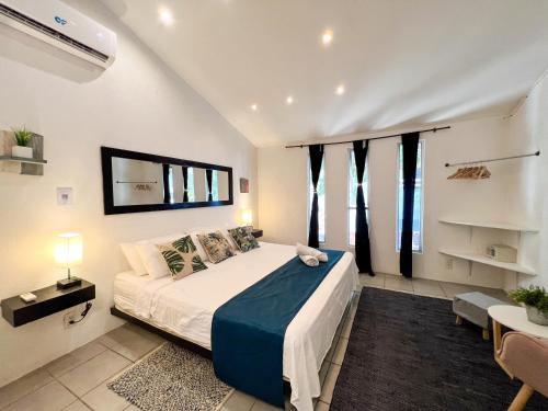 a bedroom with a bed in a room with windows at Ocean Lovers Taganga - PADI Dive Center & Hostel in Taganga