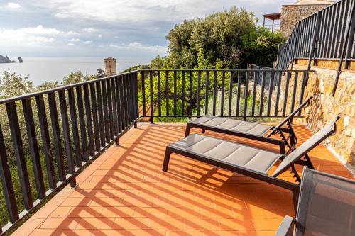 a balcony with a bench and a view of the water at Giglio Blu 5 in Isola del Giglio