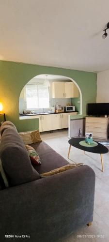 a living room with a couch and a table at cozy House with Secret Garden & Spa private in Fortuna