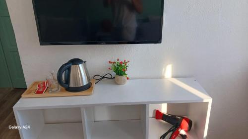 a white table with a tv on a wall at Kavala Hotel Bodrum in Bodrum City