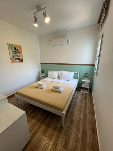 a bedroom with a bed with two towels on it at Kavala Hotel Bodrum in Bodrum City