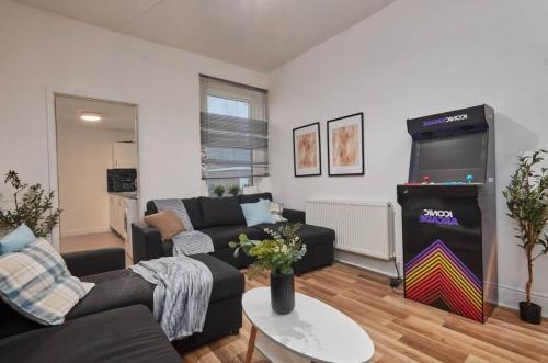 a living room with a video game in a living room at 4 bedroom, 6 beds, 10 guest, Free parking on site in Elswick